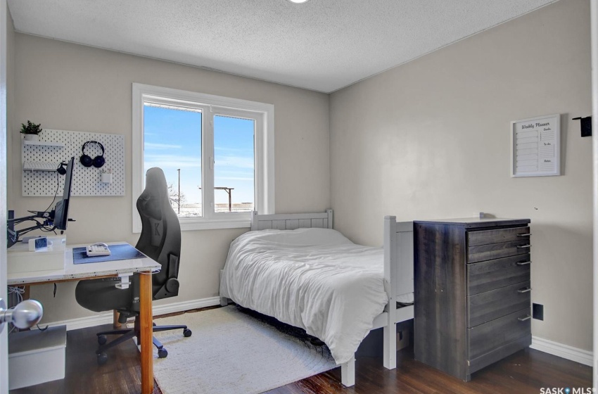 Bedroom with dark wood-type flooring and a textured ceiling