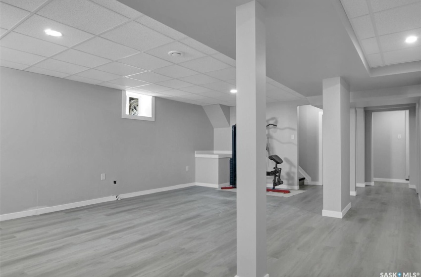 Basement featuring a drop ceiling and hardwood / wood-style flooring