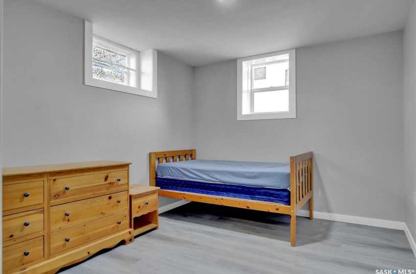 Bedroom featuring multiple windows and light wood-type flooring