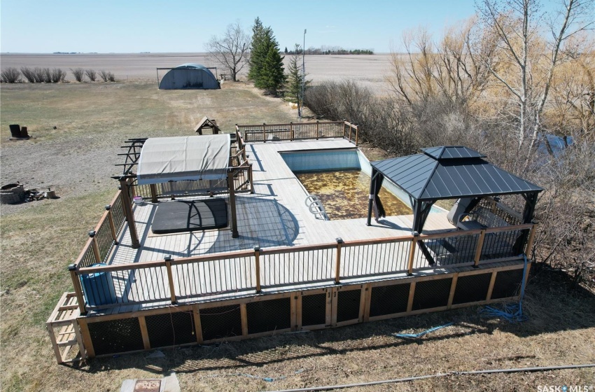 Back of property with a rural view and a deck