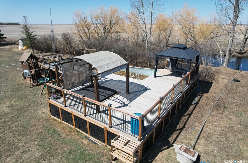 Wooden terrace with a pool and a gazebo