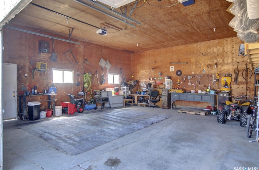 Garage featuring a garage door opener and a workshop area