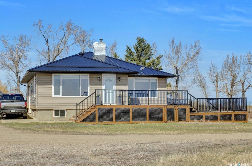 View of front of house featuring a wooden deck