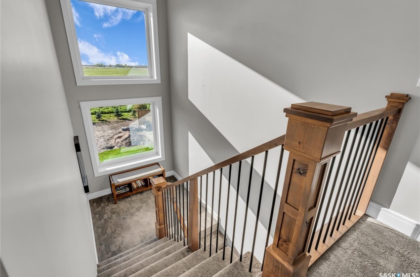 Alder Wood Railings Throughout and Large Stairwell Windows.