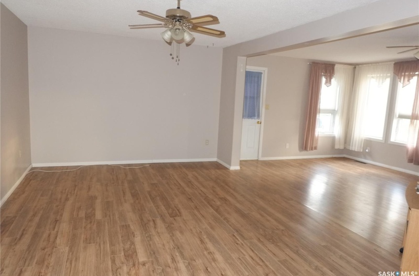 Empty room with ceiling fan and hardwood / wood-style flooring