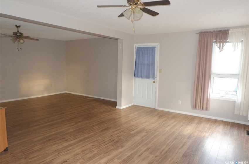 Empty room with ceiling fan and hardwood / wood-style flooring