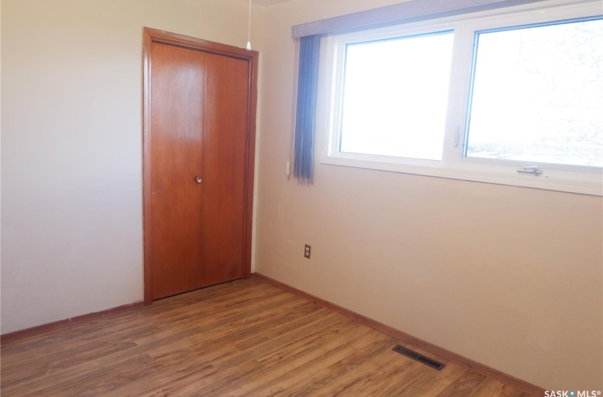 Unfurnished bedroom featuring hardwood / wood-style flooring and a closet