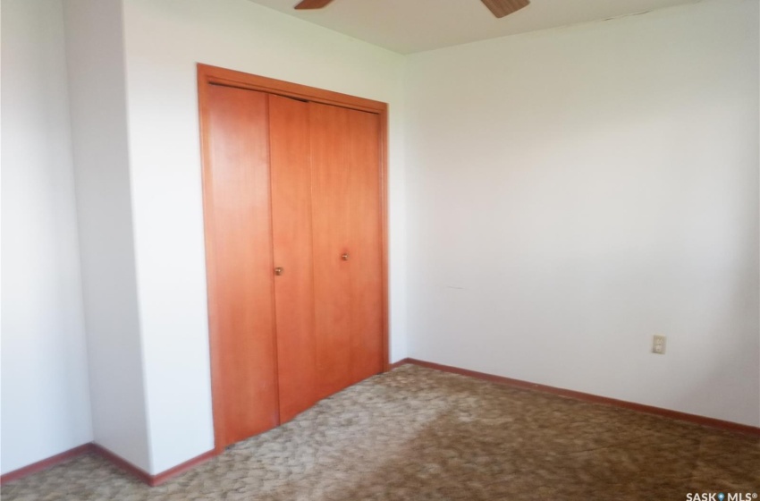 Unfurnished bedroom featuring carpet flooring, a closet, and ceiling fan