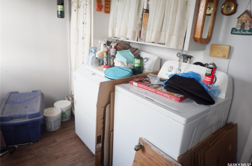 Washroom featuring dark wood-type flooring and separate washer and dryer