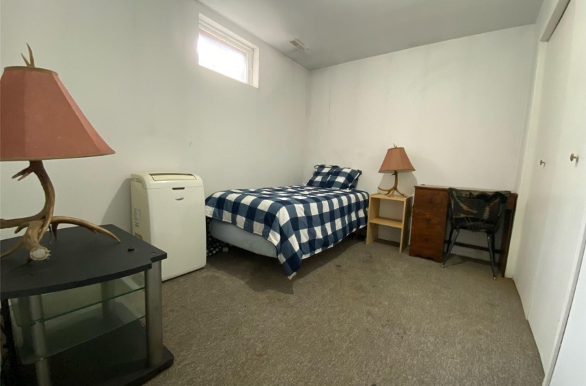 Carpeted bedroom featuring a closet