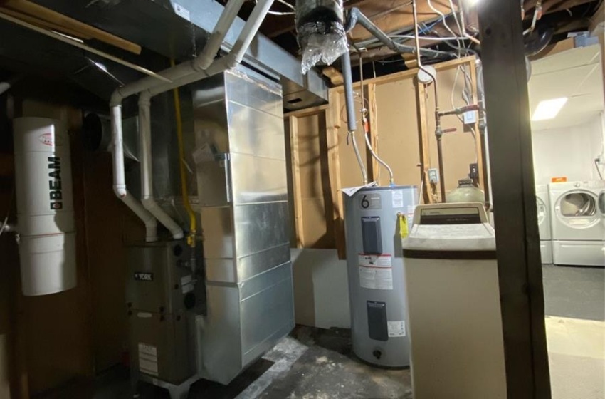 Basement featuring secured water heater and washing machine and clothes dryer