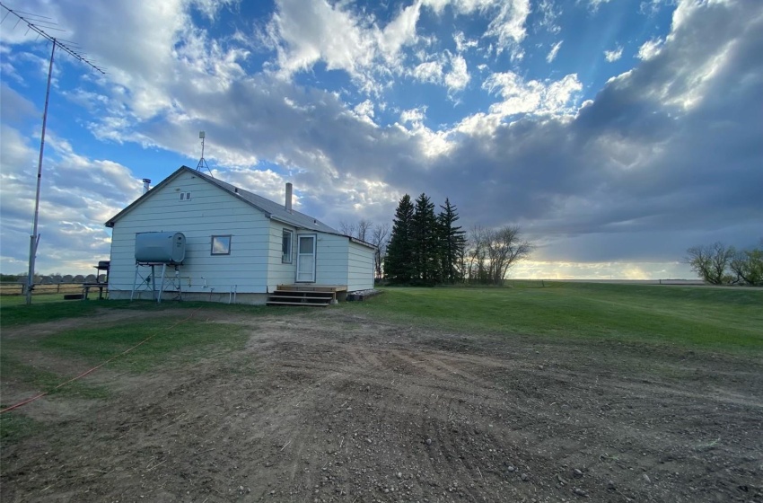 View of side of property featuring a yard