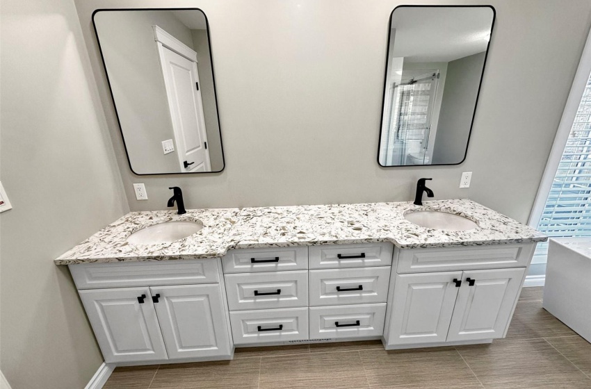 The primary ensuite features a double vanity with quartz countertop.