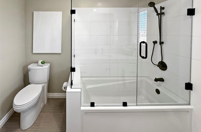 Main 4 piece bath with custom tub surround, quartz countertops.