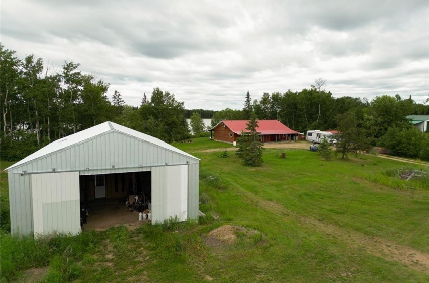 View of outdoor structure with a lawn