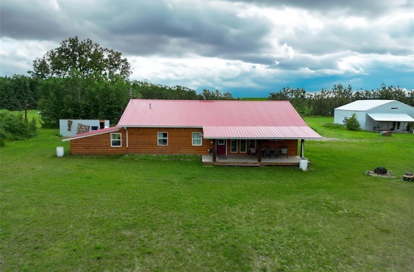 Rear view of property with a porch and a lawn