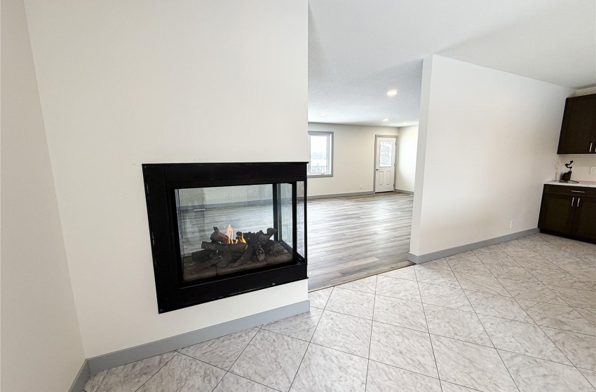 Living room featuring a multi sided fireplace