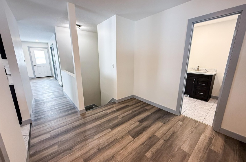 Corridor featuring wood-type flooring and sink