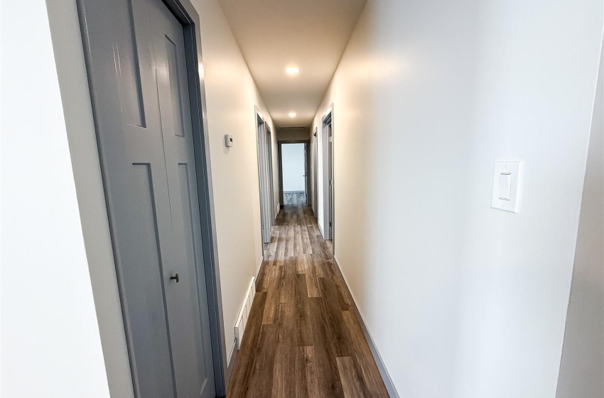 Corridor featuring dark hardwood / wood-style flooring