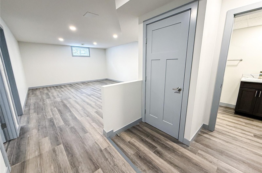 Basement with light hardwood / wood-style floors