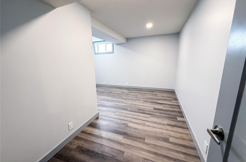 Basement with hardwood / wood-style floors