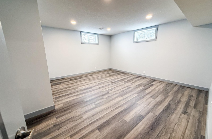 Basement featuring wood-type flooring