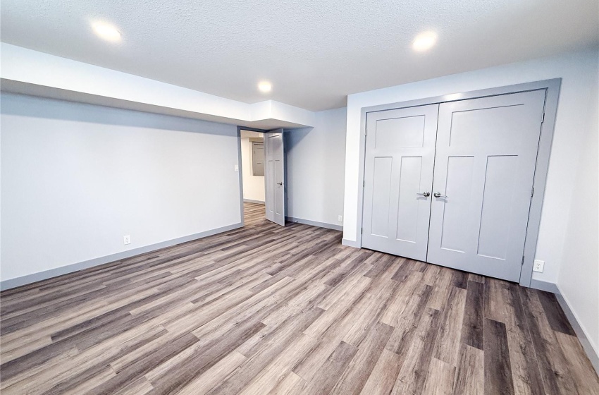 Basement featuring light hardwood / wood-style floors and a textured ceiling