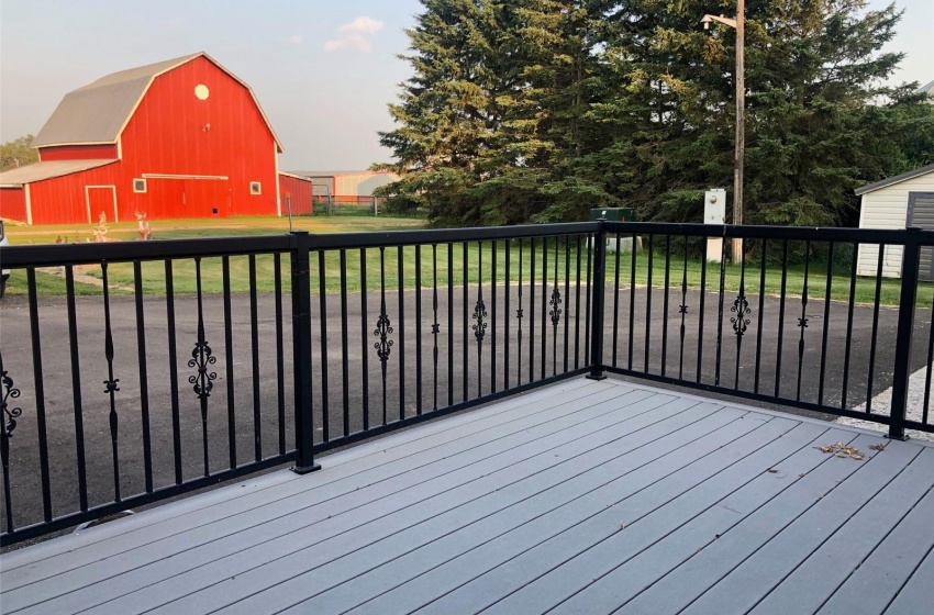 Wooden terrace featuring a yard