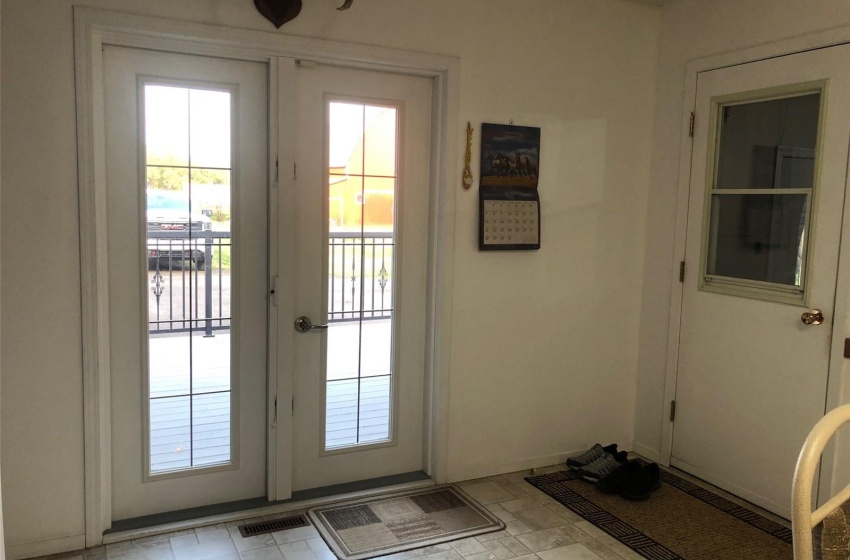 Doorway with light tile patterned flooring and french doors