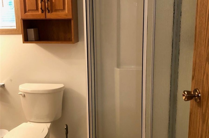 Bathroom with tile patterned floors, an enclosed shower, and toilet