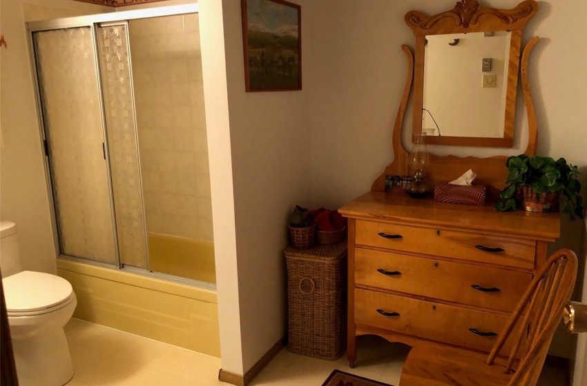 Full bathroom with tile patterned flooring, combined bath / shower with glass door, toilet, and vanity