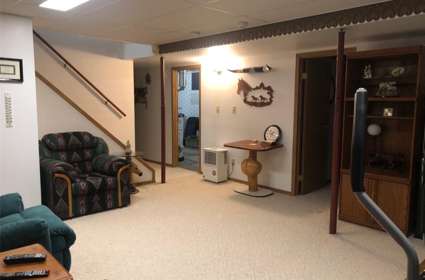 Living room with carpet floors and a paneled ceiling