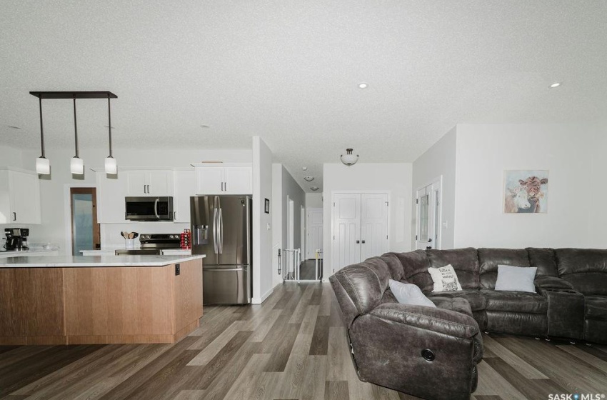 Living room with a textured ceiling and dark hardwood / wood-style flooring