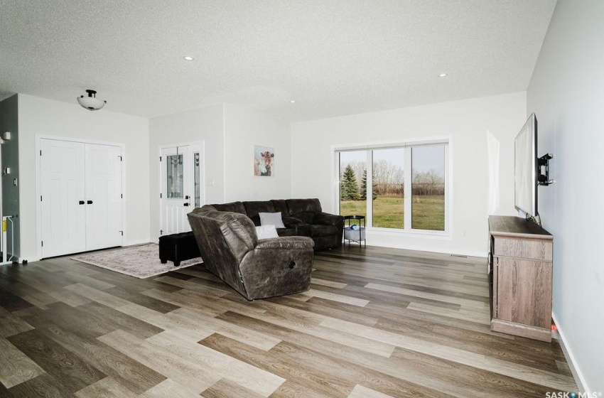 Living room featuring light hardwood / wood-style floors and a textured ceiling