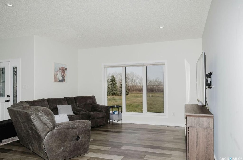 Living room featuring light hardwood / wood-style floors and a textured ceiling