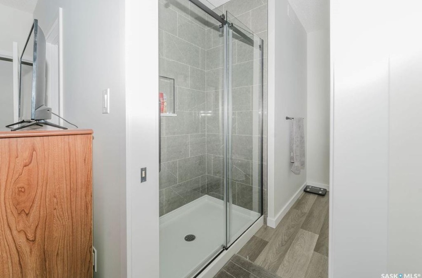 Bathroom with hardwood / wood-style floors and walk in shower