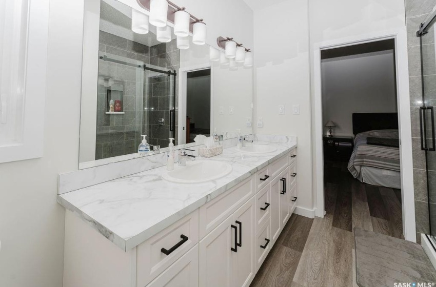 Bathroom with vanity, walk in shower, and hardwood / wood-style floors