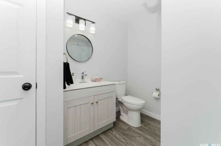 Bathroom with vanity, wood-type flooring, and toilet