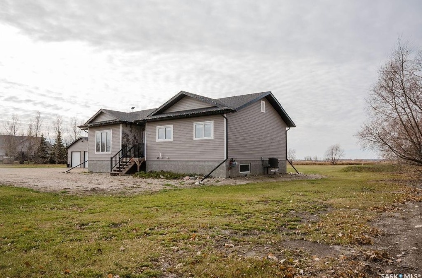 View of side of property with a yard and central AC unit