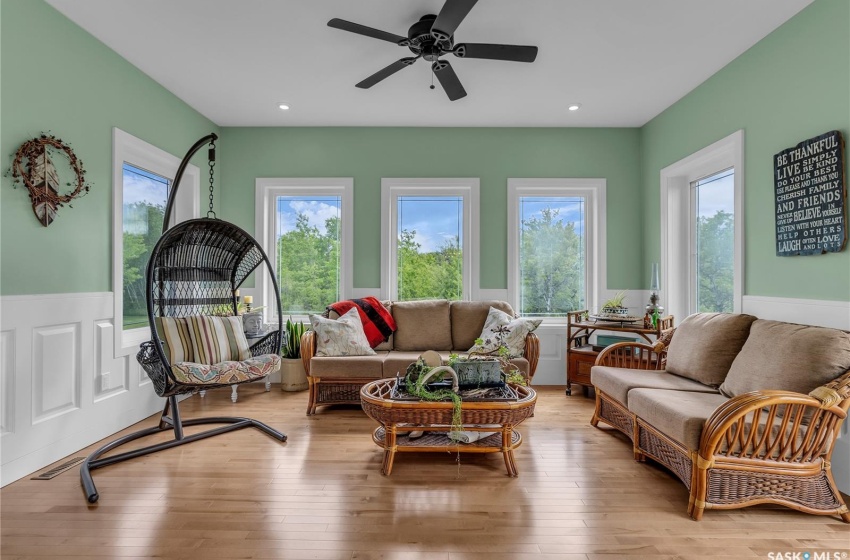 Living room featuring ceiling fan and light hardwood floors