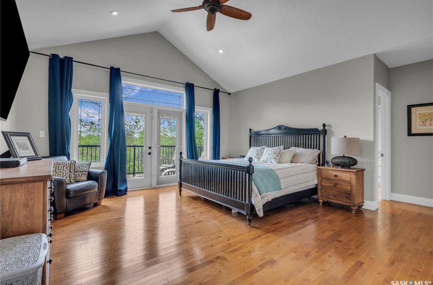 Bedroom featuring french doors, ceiling fan, hardwood flooring, and access to outside