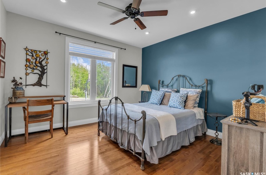 Bedroom featuring ceiling fan and hardwood flooring