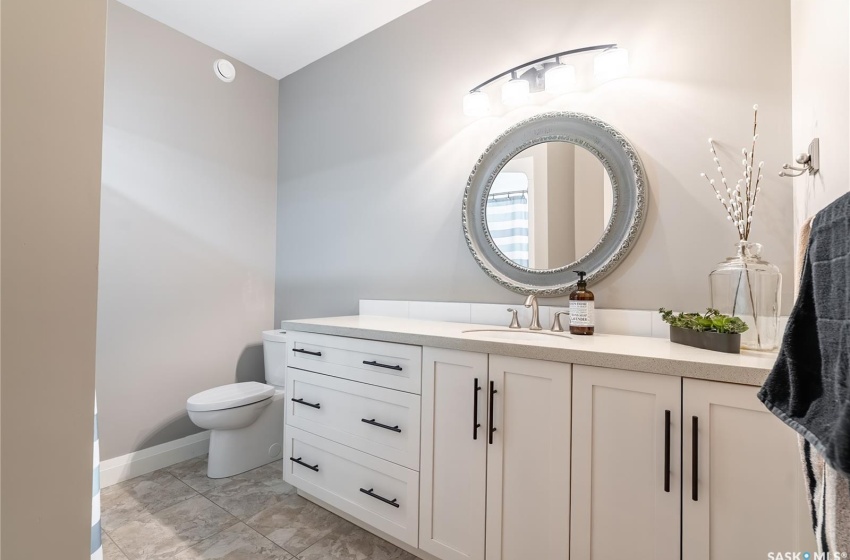 Bathroom with tile flooring, vanity, and toilet