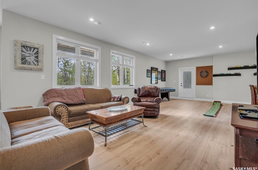 Living room with pool table and laminate plank flooring