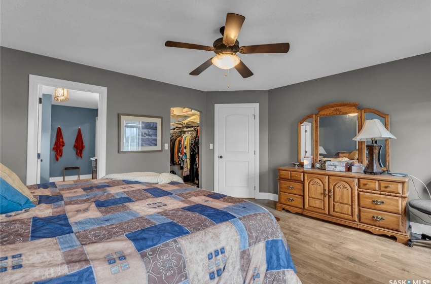 Bedroom with a closet, ceiling fan, and a walk in closet