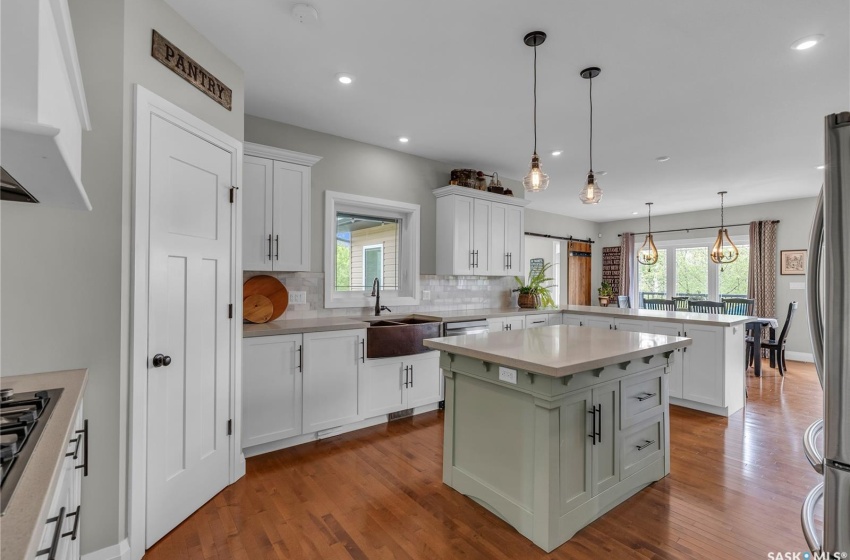 Kitchen featuring a healthy amount of sunlight, hardwood flooring, and a kitchen island