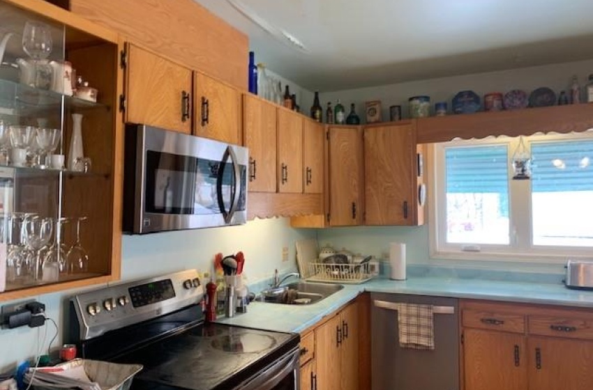 Kitchen featuring sink and appliances with stainless steel finishes