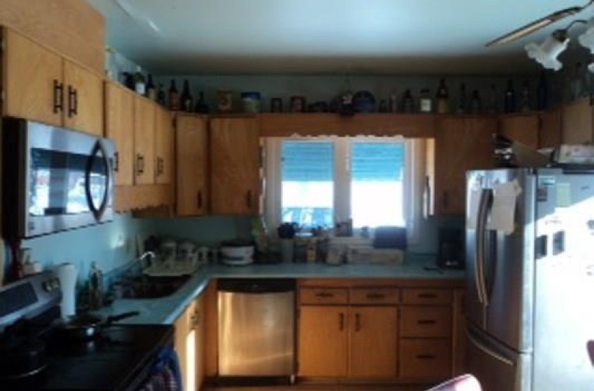 Kitchen with ceiling fan, sink, and appliances with stainless steel finishes