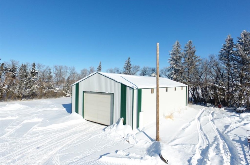 Snow covered structure with a garage