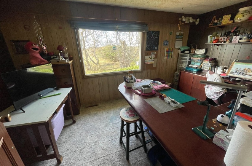 Carpeted office with wooden walls